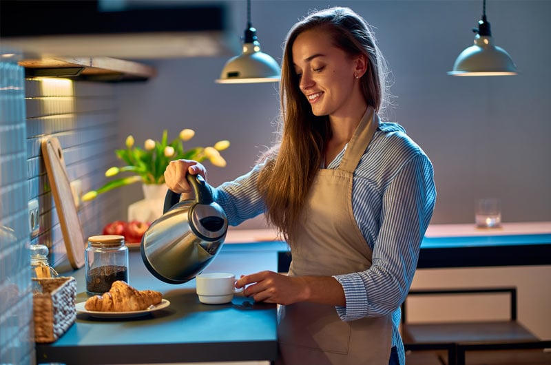 woman with a kettle in kitchen (2)